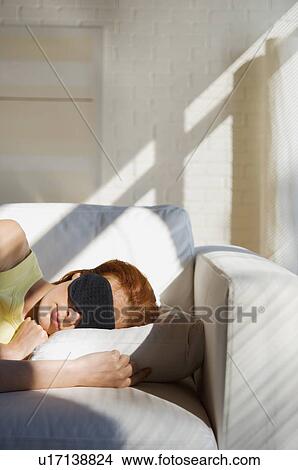 Woman sleeping with mask on sofa View Large Photo Image Picture - Woman sleeping with mask on sofa. Fotosearch