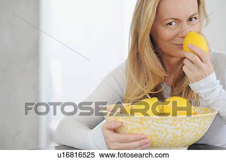 Woman smelling lemons View Large Photo Image Stock Photography - Woman smelling lemons. Fotosearch