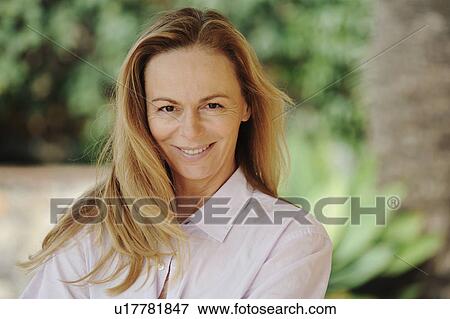 Woman smiling in backyard View Large Photo Image Stock Photo - Woman smiling in backyard. Fotosearch