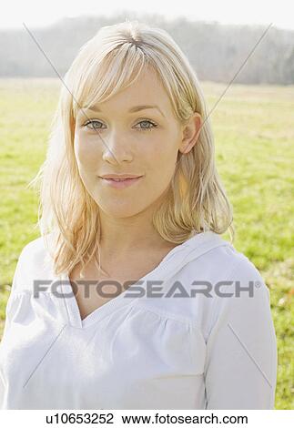 Woman smiling in field View Large Photo Image Stock Image - Woman smiling in field. Fotosearch