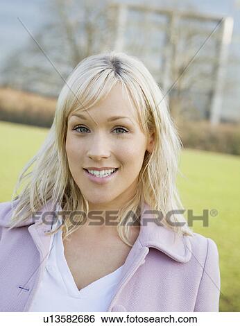 Stock Photograph - Woman smiling in field. Fotosearch