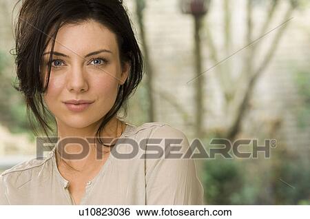 Stock Photograph - Woman smiling outdoors. Fotosearch