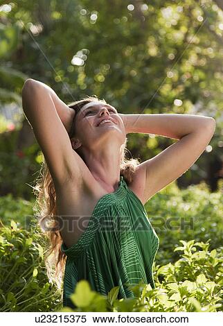 Woman standing in forest View Large Photo Image Stock Photography - Woman standing in forest. Fotosearch