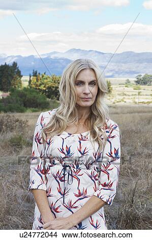 Woman standing in tall grass View Large Photo Image Picture - Woman standing in tall grass. Fotosearch