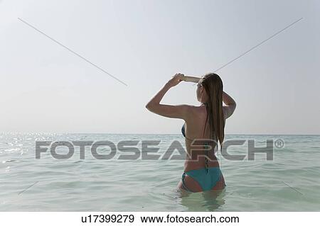 Woman standing in water View Large Photo Image Stock Photo - Woman standing in water. Fotosearch