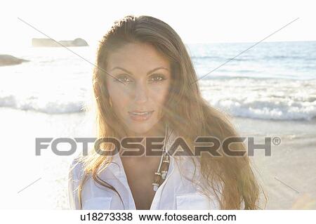Woman standing on beach View Large Photo Image Stock Photo - Woman standing on beach. Fotosearch