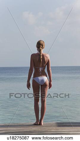 Woman standing on deck overlooking sea View Large Photo Image Stock Photo - Woman standing on deck overlooking sea. Fotosearch