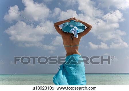 Woman standing on tropical beach View Large Photo Image Stock Photography - Woman standing on tropical beach. Fotosearch