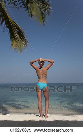 Woman standing on tropical beach View Large Photo Image Stock Photography - Woman standing on tropical beach. Fotosearch