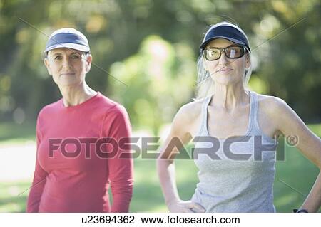 Woman standing together outdoors View Large Photo Image Stock Image - Woman standing together outdoors. Fotosearch