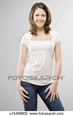 Stock Image - Woman standing with hands on hips. Fotosearch