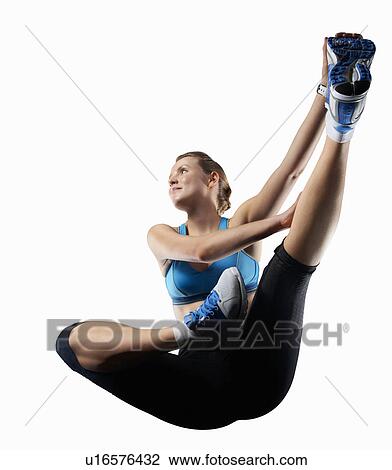 Stock Image - Woman stretching before exercise. Fotosearch