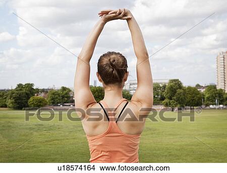 Picture - Woman stretching in park. Fotosearch
