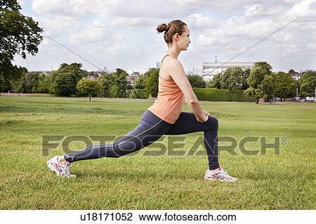 Woman stretching in park View Large Photo Image Stock Image - Woman stretching in park. Fotosearch