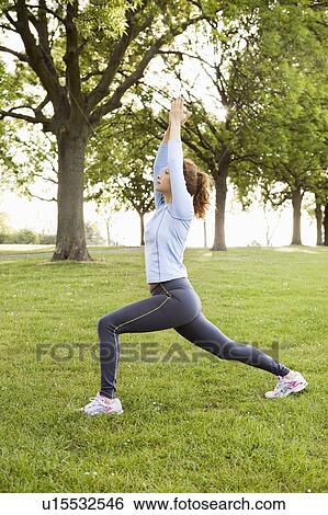 Woman stretching in park View Large Photo Image Stock Photograph - Woman stretching in park. Fotosearch