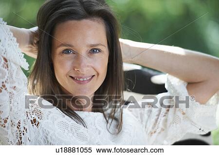 Woman stretching outdoors View Large Photo Image Stock Photography - Woman stretching outdoors. Fotosearch