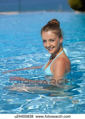 Stock Photo - Woman swimming in pool. Fotosearch