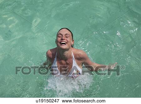 Stock Photo - Woman swimming in tropical sea. Fotosearch