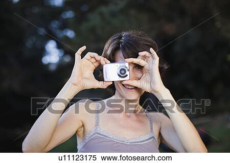Woman taking a picture outdoors View Large Photo Image Stock Photography - Woman taking a picture outdoors. Fotosearch