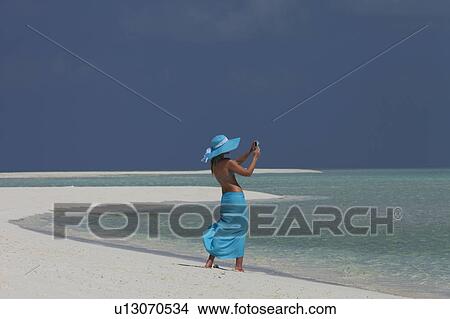 Woman taking pictures on tropical beach View Large Photo Image Picture - Woman taking pictures on tropical beach. Fotosearch