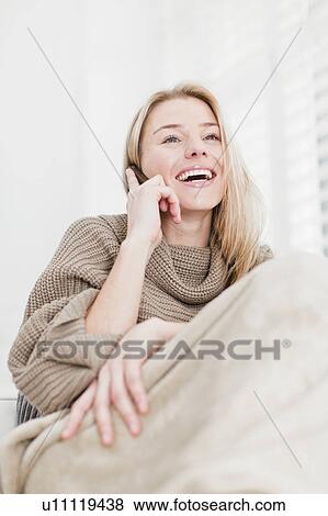 Woman talking on cell phone on couch View Large Photo Image Stock Photo - Woman talking on cell phone on couch. Fotosearch