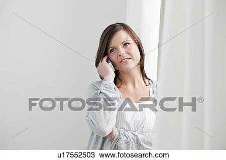 Stock Image - Woman talking on telephone. Fotosearch
