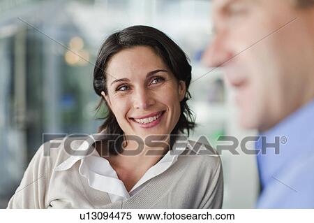 Stock Photography - Woman talking to man at cafe. Fotosearch