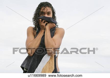 Stock Photo - Woman toweling off on beach. Fotosearch