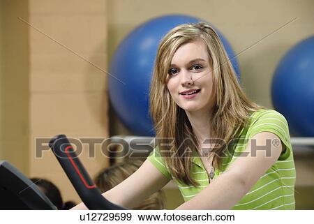 Woman using elliptical machine View Large Photo Image Stock Photo - Woman using elliptical machine. Fotosearch