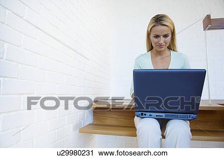 Woman using laptop on stairs View Large Photo Image Stock Image - Woman using laptop on stairs. Fotosearch