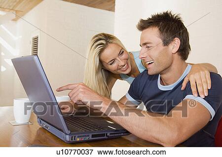 Stock Photo - Woman using laptop on stairs. Fotosearch