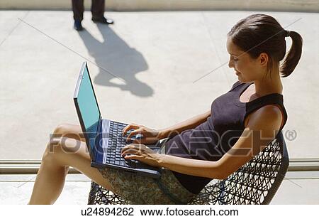 Woman using laptop outdoors View Large Photo Image Stock Image - Woman using laptop outdoors. Fotosearch