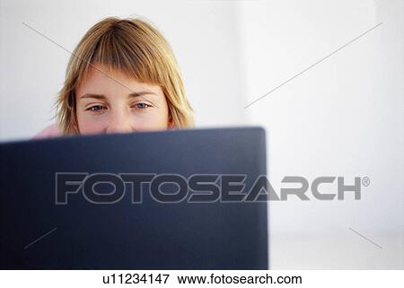 Stock Photo - Woman using laptop. Fotosearch