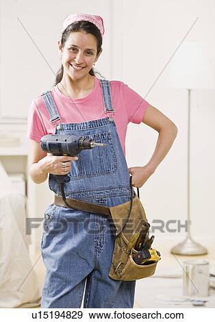 Woman using power tools at home View Large Photo Image Stock Photo - Woman using power tools at home. Fotosearch