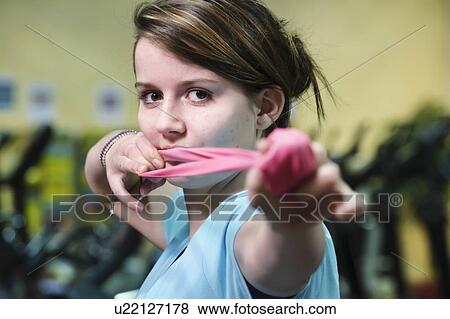 Stock Photo - Woman using stretcher in gym. Fotosearch