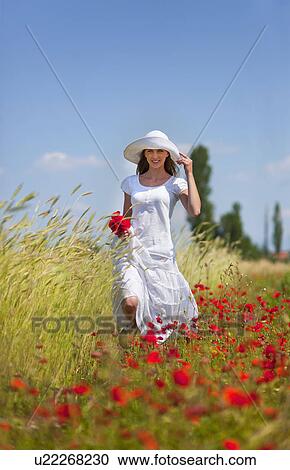 Woman walking in field of flowers View Large Photo Image Stock Image - Woman walking in field of flowers. Fotosearch