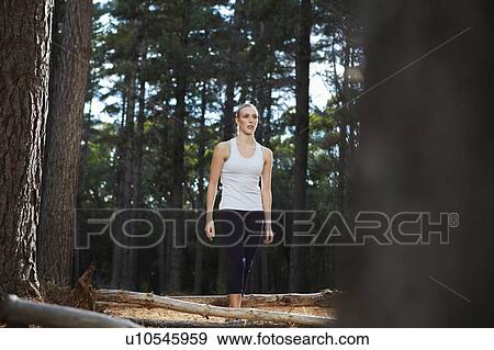 Stock Photo - Woman walking in forest. Fotosearch