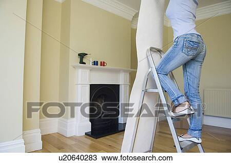 Woman wallpapering new home View Large Photo Image Stock Image - Woman wallpapering new home. Fotosearch