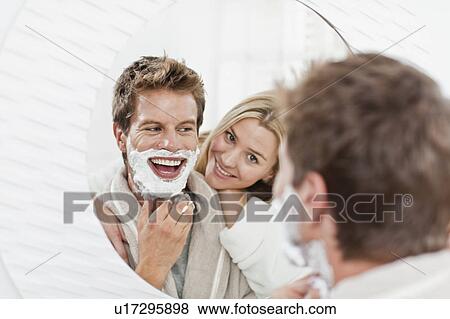 Stock Photo - Woman watching boyfriend shave. Fotosearch