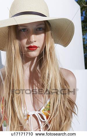 Stock Image - Woman wearing bikini and straw hat. Fotosearch