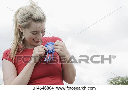 Woman wearing blue ribbon outdoors View Large Photo Image Picture - Woman wearing blue ribbon outdoors. Fotosearch