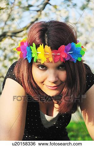 Stock Photograph - Woman wearing colorful lei on head. Fotosearch