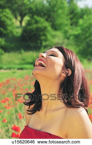 Stock Photograph - Woman wearing evening gown in field. Fotosearch