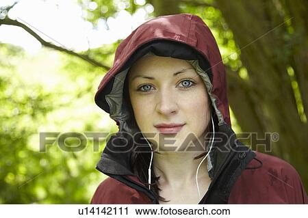 Woman wearing parka and headphones View Large Photo Image Stock Image - Woman wearing parka and headphones. Fotosearch