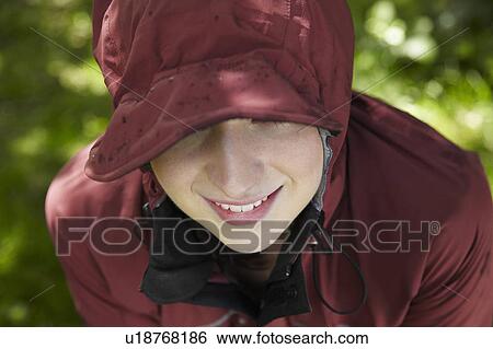 Stock Photograph - Woman wearing parka in forest. Fotosearch