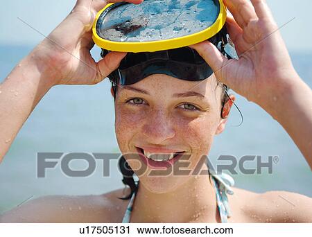 Stock Image - Woman wearing snorkeling mask. Fotosearch