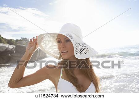 Woman wearing sunhat on beach View Large Photo Image Picture - Woman wearing sunhat on beach. Fotosearch