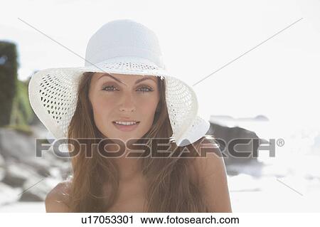 Woman wearing sunhat on beach View Large Photo Image Stock Image - Woman wearing sunhat on beach. Fotosearch