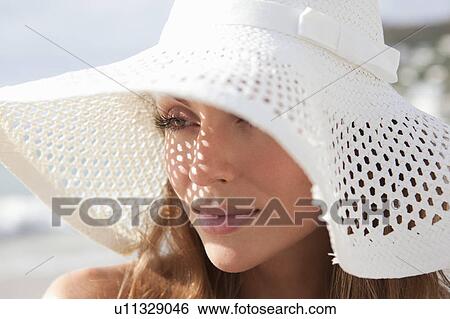Woman wearing sunhat on beach View Large Photo Image Stock Photograph - Woman wearing sunhat on beach. Fotosearch