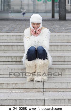 Woman wearing winter clothes on steps View Large Photo Image Stock Photo - Woman wearing winter clothes on steps. Fotosearch